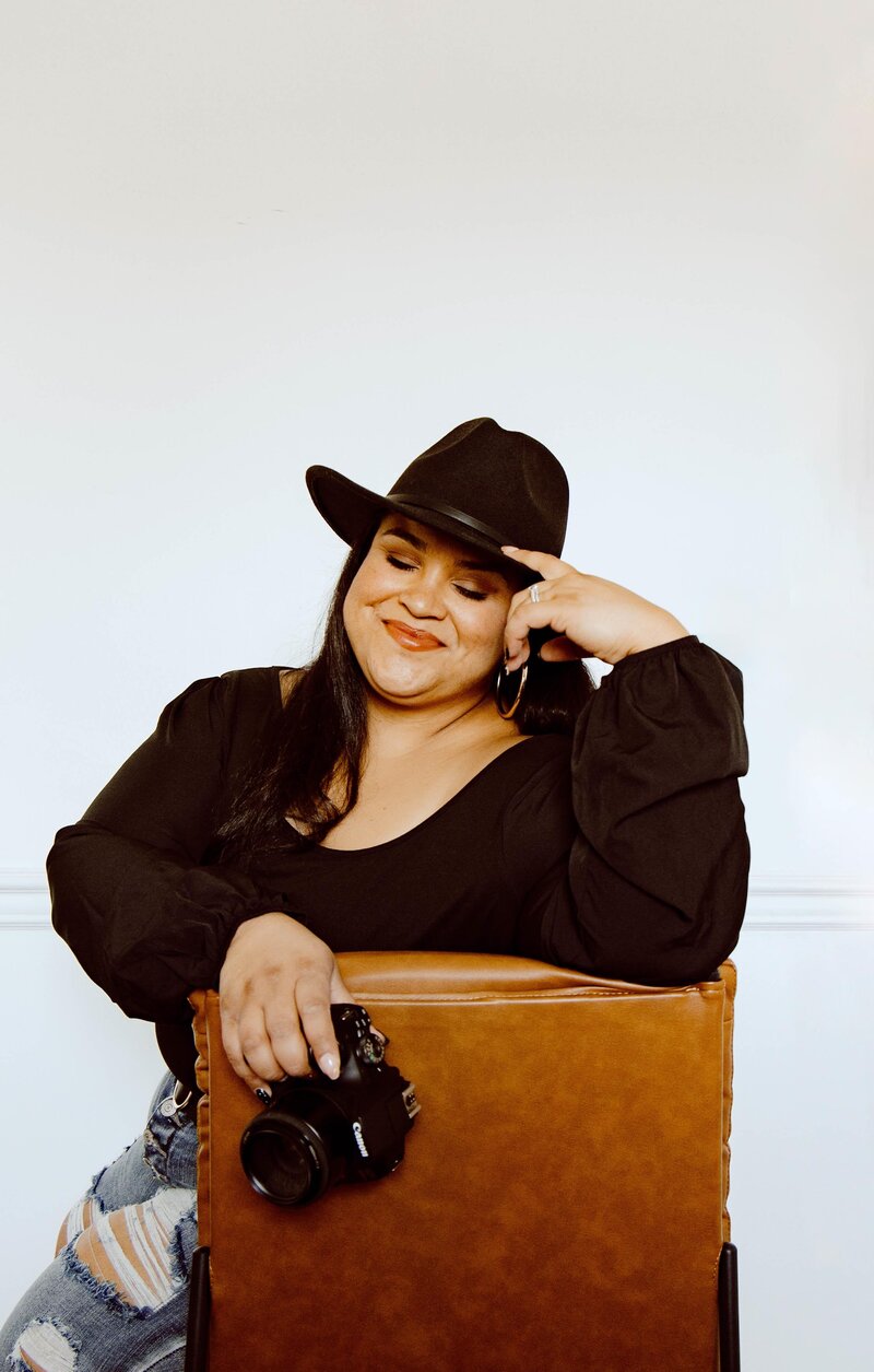 woman sitting on chair and holding camera