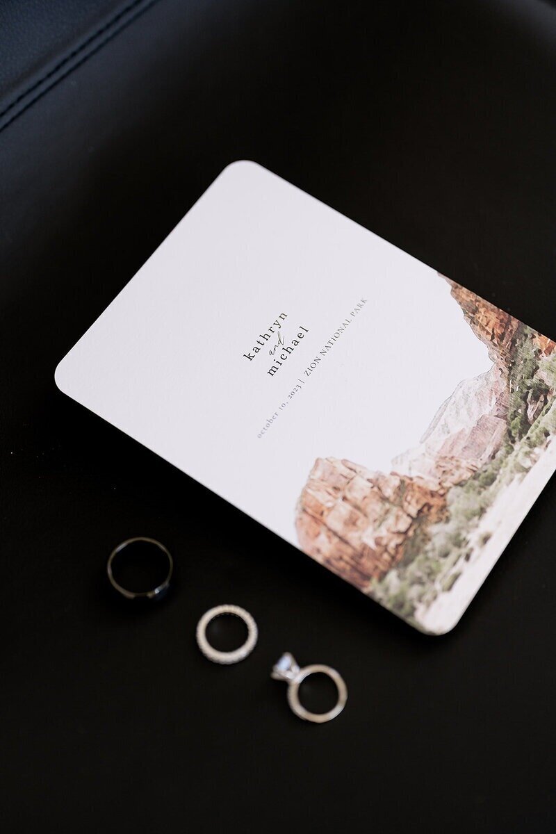 wedding details and rings on a dark background