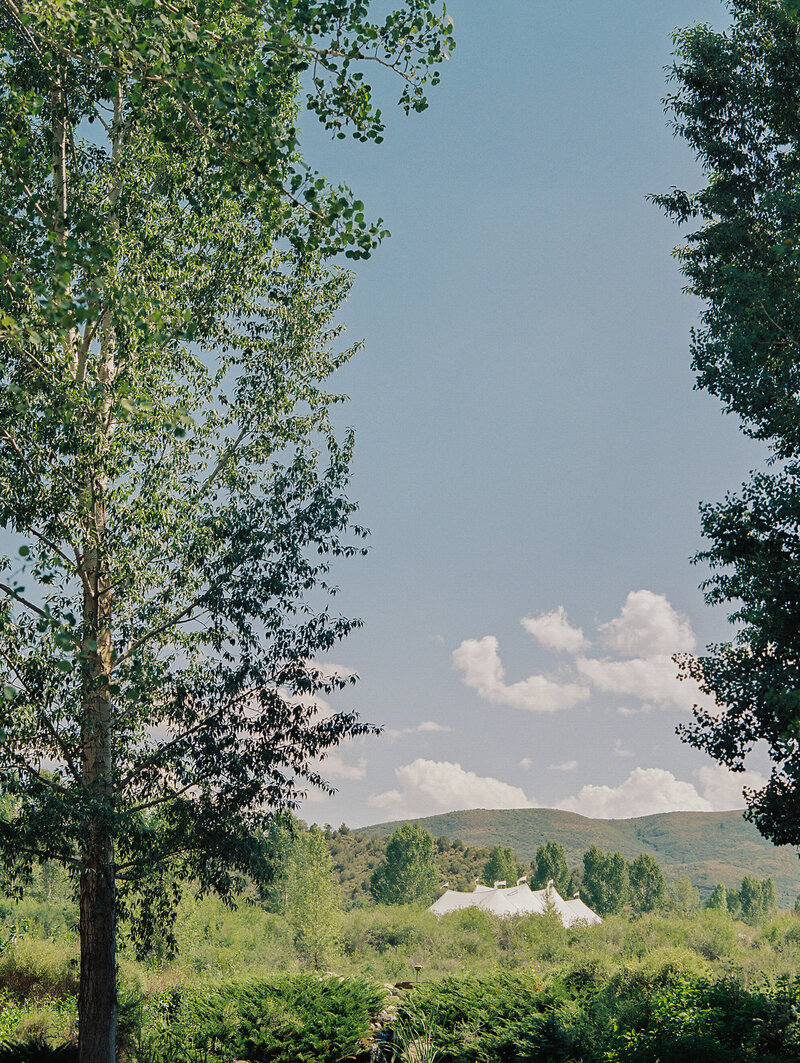 mountains with wedding tent in the distance