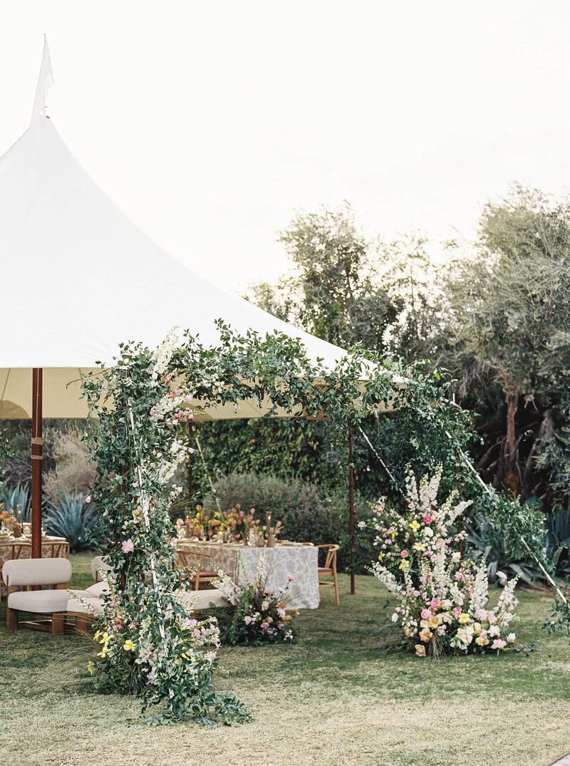 Luxury wedding photographer capturing an elegant garden reception with lush flowers and greenery, creating a timeless fine art wedding setting in Arizona.