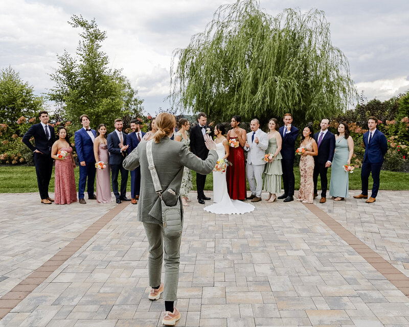 Behind the scenes of Megan and Kenneth photographing a wedding party group portrait outdoors
