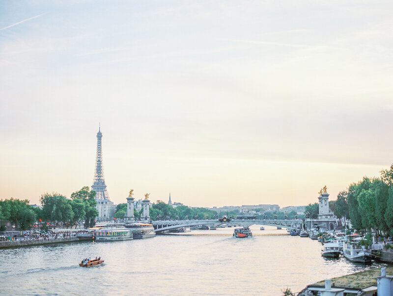 Bride Smiles Joyfully on Pont Alexander III Bridge captured by Luxury Destination Wedding Photographer Katie Trauffer