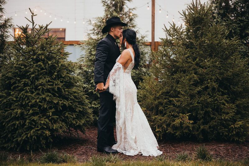 Wedding session photo of groom kissing bride's forehead