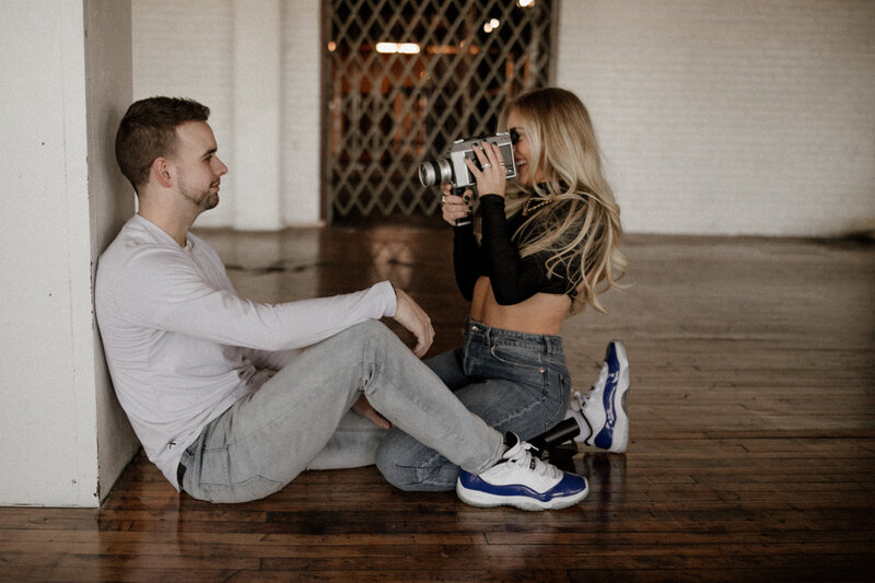 couple sitting using vintage camera