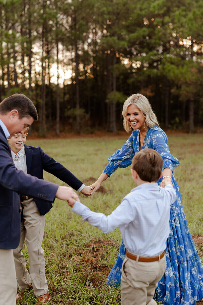 two young sisters hold hands and run around during their family session