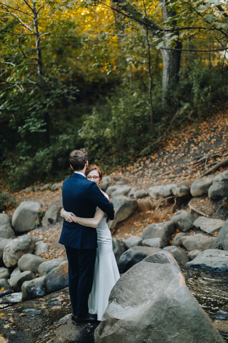 Elopement portraits of a couple by a rocky creek in the Hudson Valley