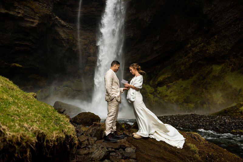 saying vows in front of a waterfall in Iceland for an elopement