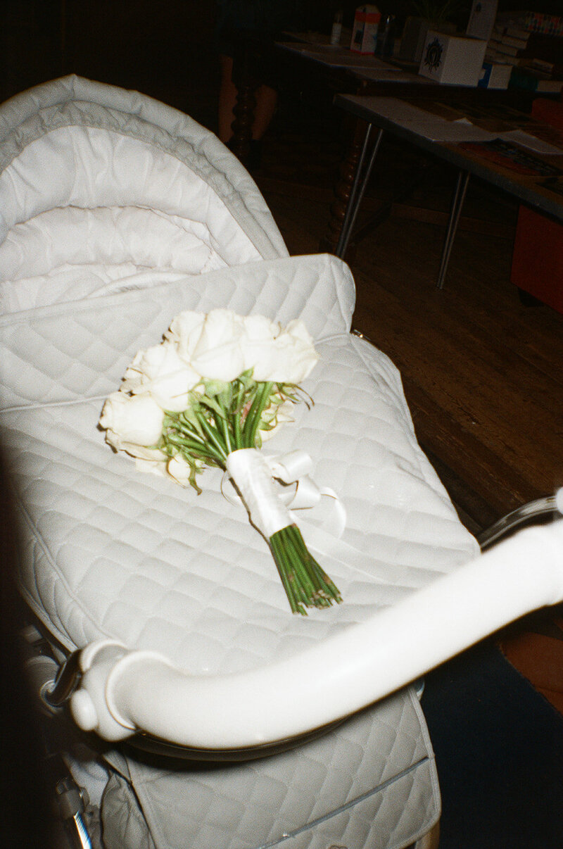 Photograph of a wedding bouquet on a silvercross pram shot with direct flash on 35mm film