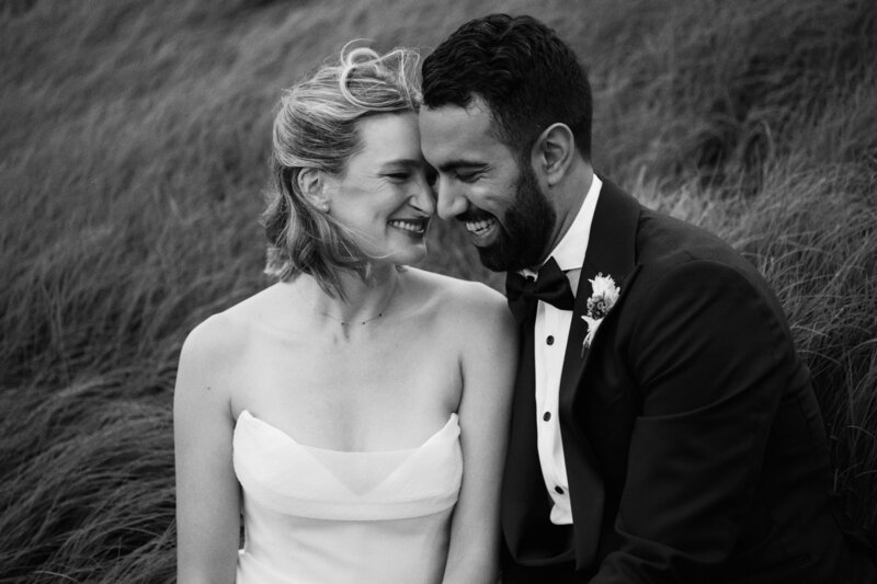 couple standing in front of car on wedding day