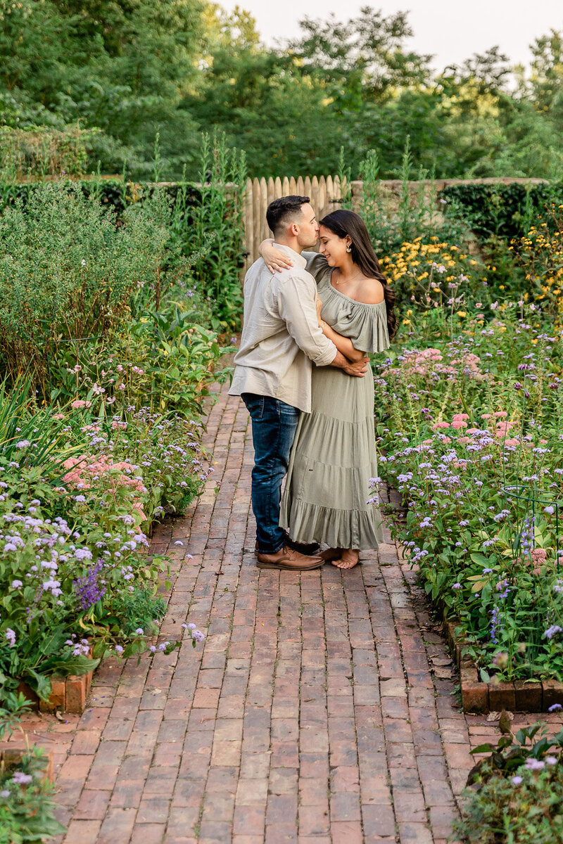 Couple embracing in flower garden in Bernardsville, NJ