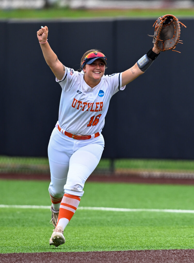 a college softball player celebrates a win in a sports action photograph