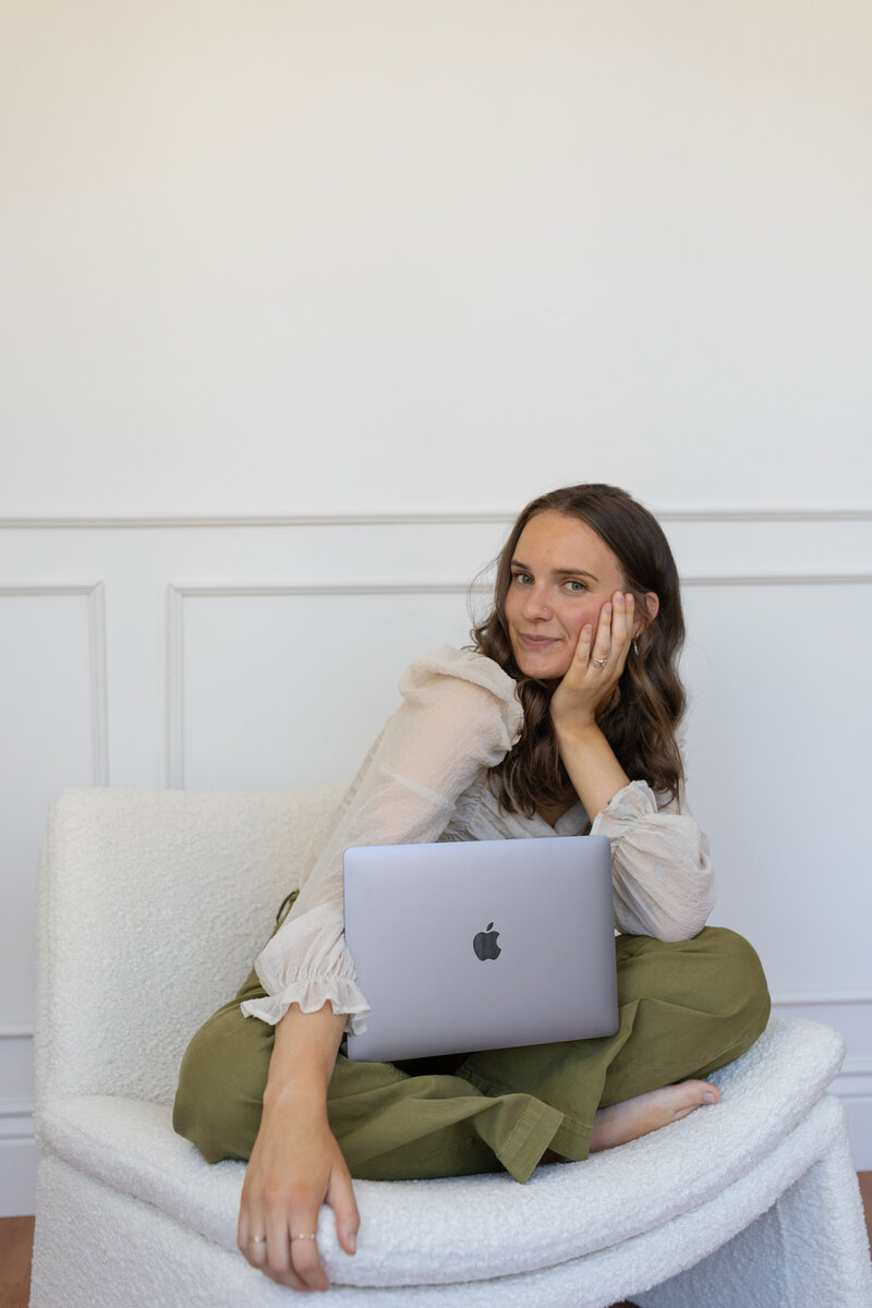 A woman working on freelance website design on her computer.