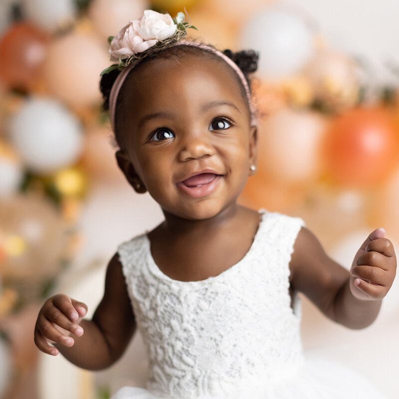 Girl smiling at her first birthday photoshoot