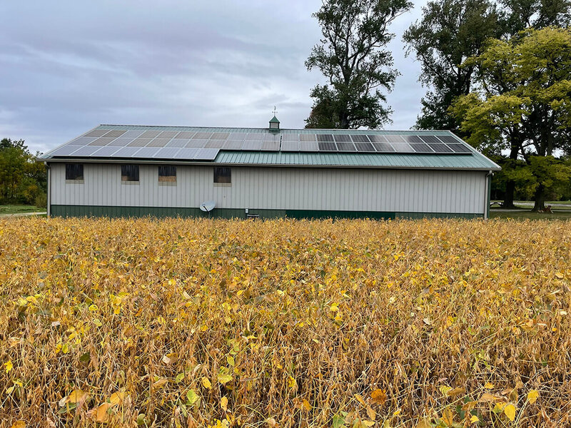 solar panels on farm building in a field