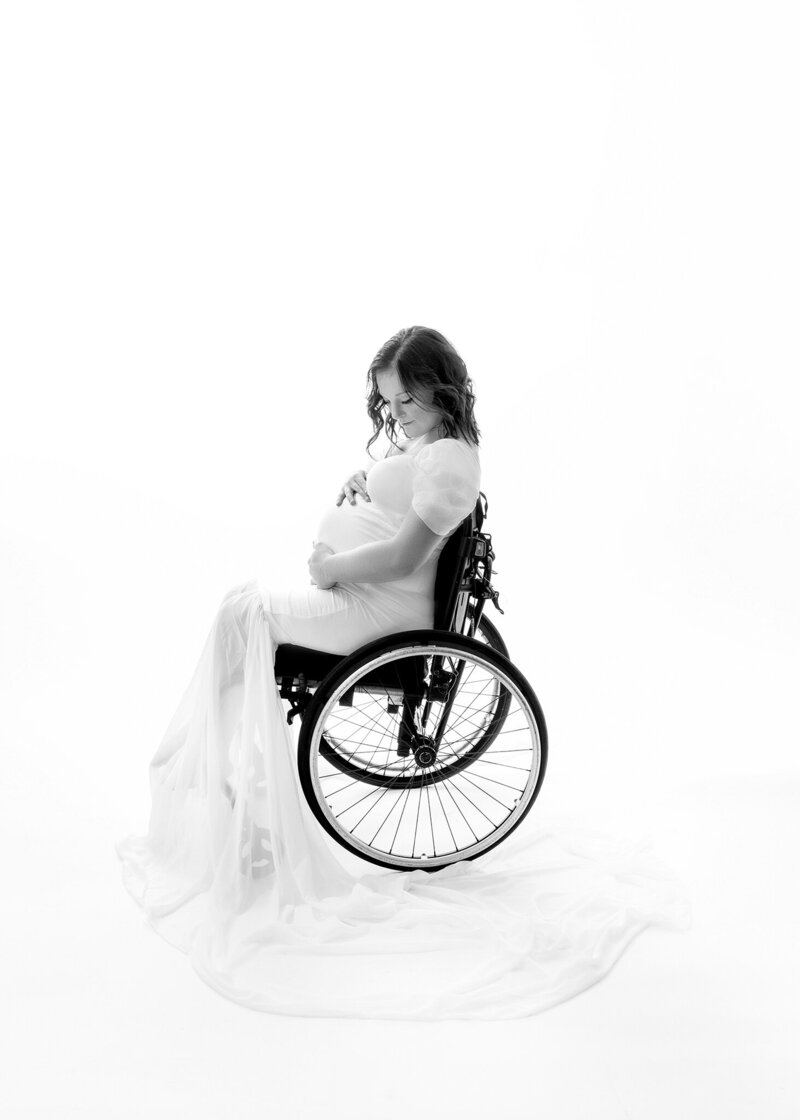 Pregnant, mom with cerebral palsy  in her wheelchair