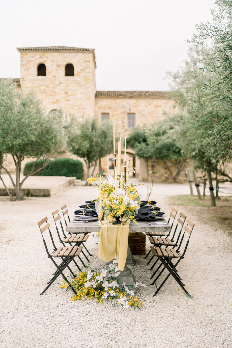 Tiffany Longeway Photography captures the stunning and sophisticated outdoor table setting at Sunstone Winery in Santa Ynez, California. The Mediterranean-inspired architecture and lush olive trees provide a beautiful and picturesque backdrop.