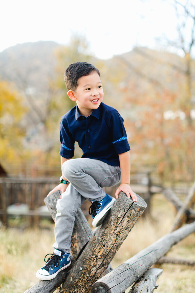 mom and son sit in a window sill during broomfield photography session