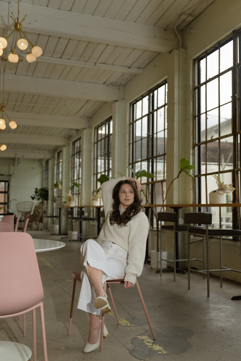 A website copywriter posing in a coffee shop