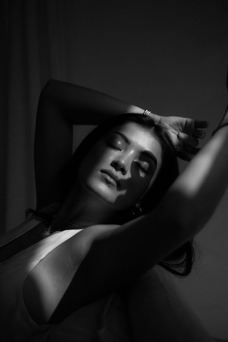 woman leaned back with sun hitting her face
