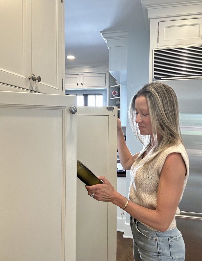 Jen, an integrative health coach, examining ingredients in her pantry, focused on organizing and selecting wholesome options for healthy meal preparation.