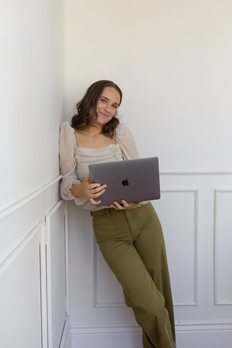 A woman working on freelance website design on her computer.
