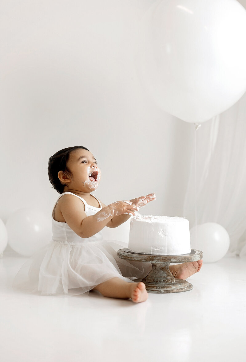 A baby sits on a a little bed during a Vancouver Photoshoot
