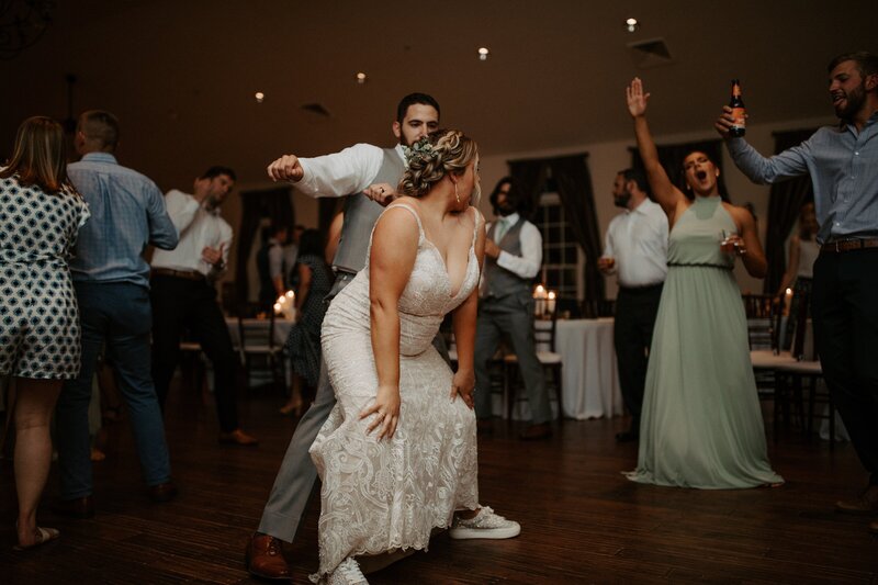 bride dancing with friends at wedding reception