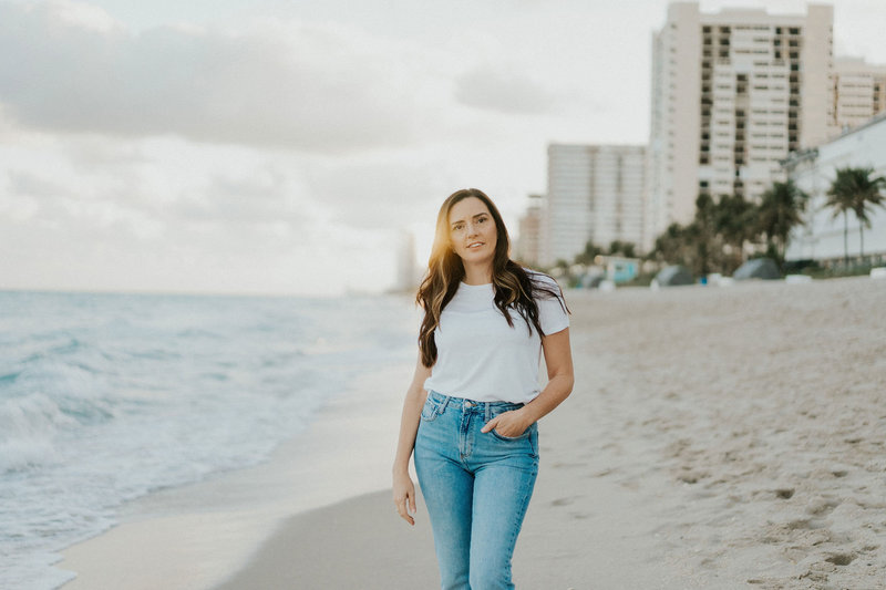 Idit Sharoni stands on a beach  as the sun sets behind her. She offers support for relationships with infidelity recovery in Florida. Contact us for support with recovering from an affair today.