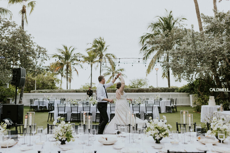 Jess and Branden dancing in front of their tables.