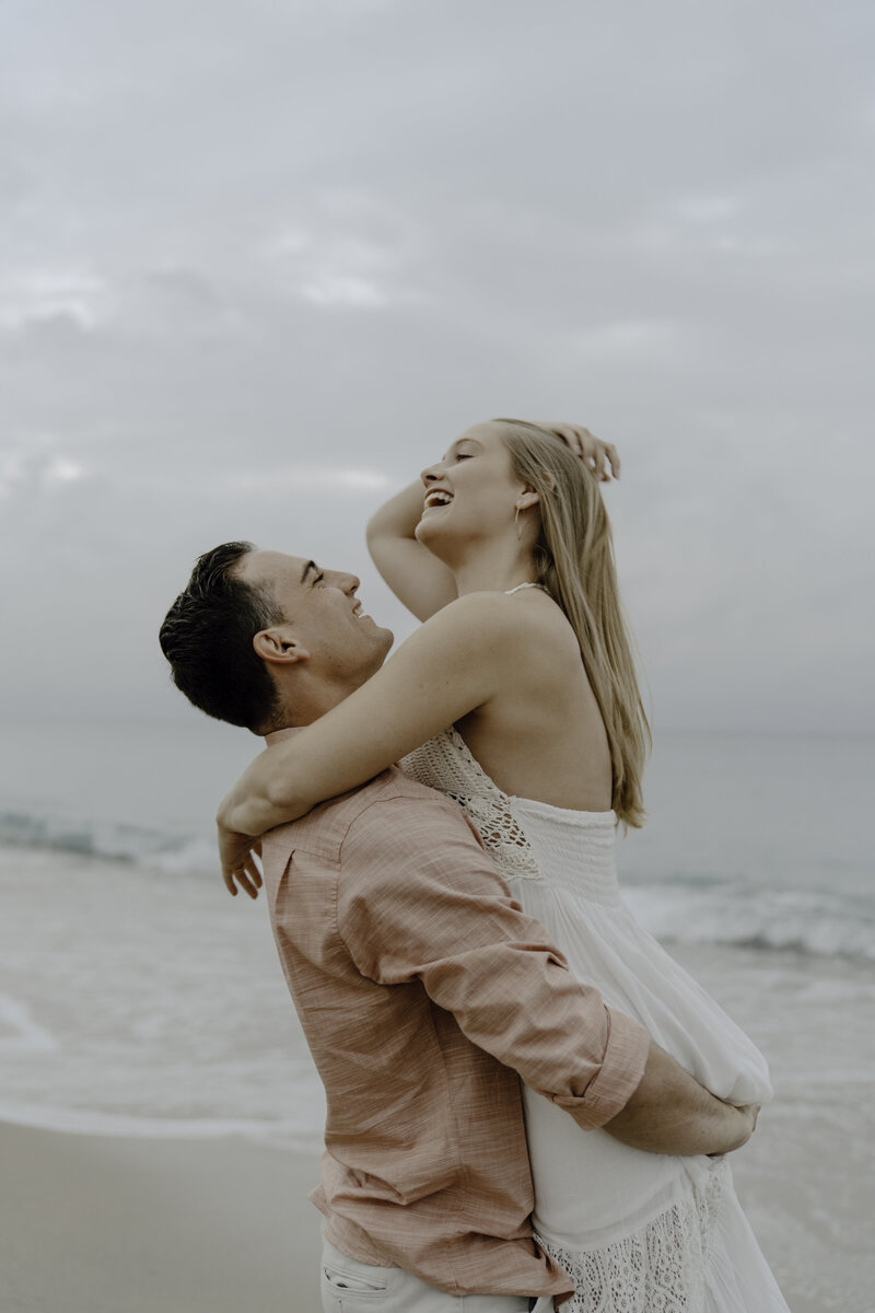 couples laughing on beach