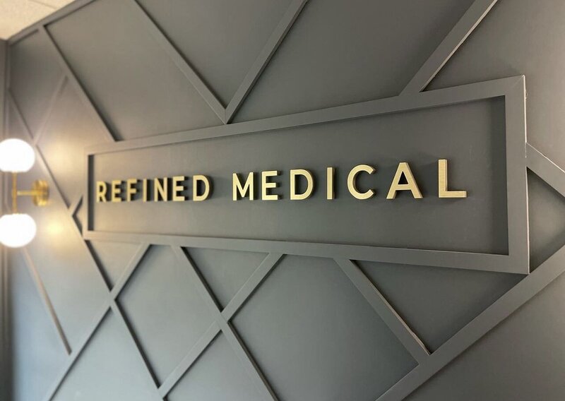 Refined Medical branding on the wall inside the clinic in East Setauket Long Island, showcasing the welcoming and professional environment of the medical spa.