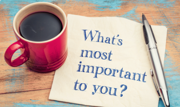 A coffee cup and a pen laid on a note asking What's most Important To You?