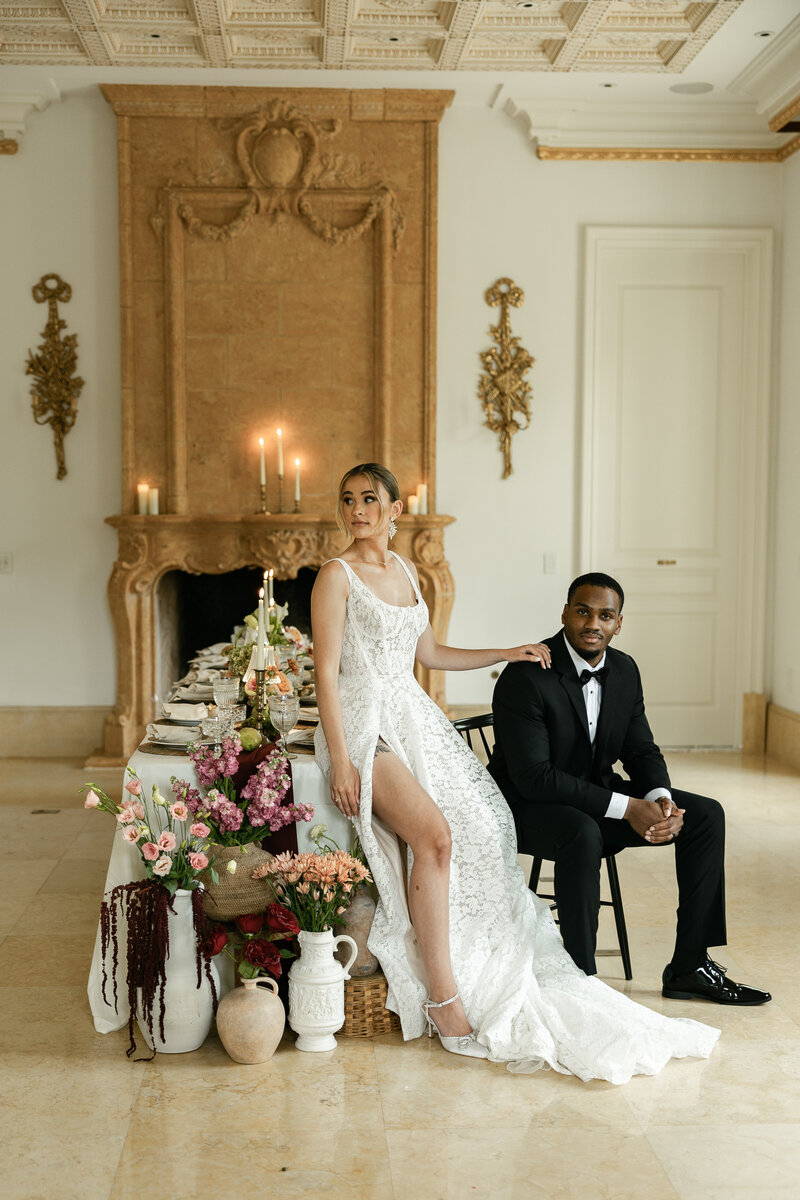 husband and wife is ornate dining room sitting on dining table and chairs