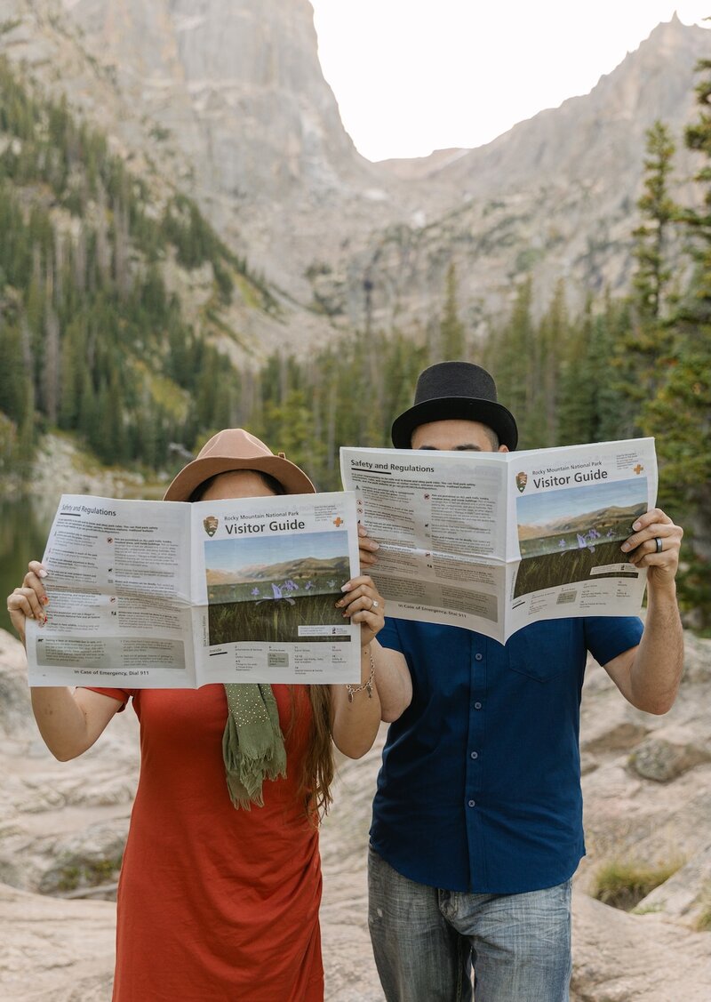 Couple reading a newspaper at Dream Lake in Rocky Mountain National Park