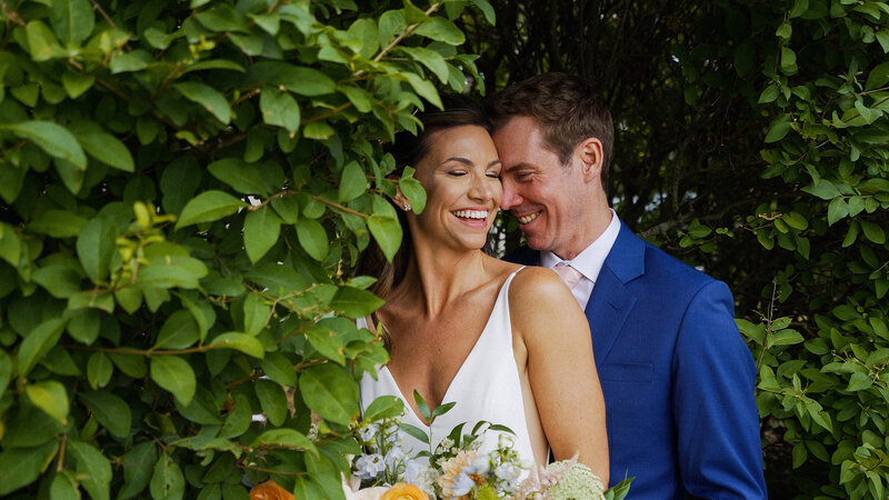 Bride and Groom behind a tree