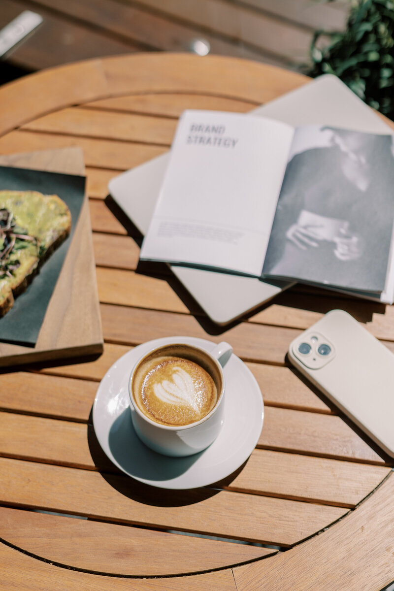 Workspace with laptop and open notebook, perfect for planning marketing strategies.