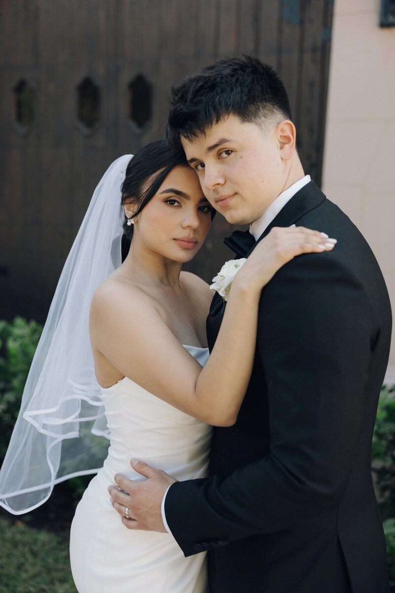 bride and groom embrace after wedding in south florida