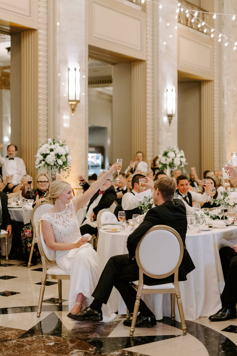 Bride and groom toast along with guests at their Stifel Theatre wedding in St. Louis