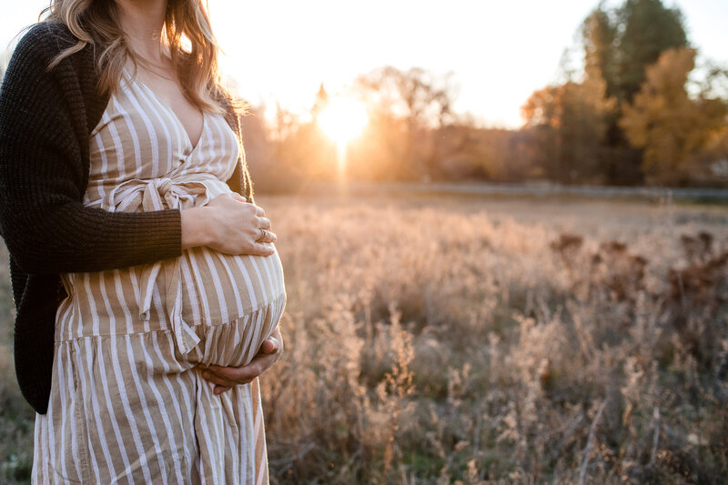 maternity photography in field golden hour