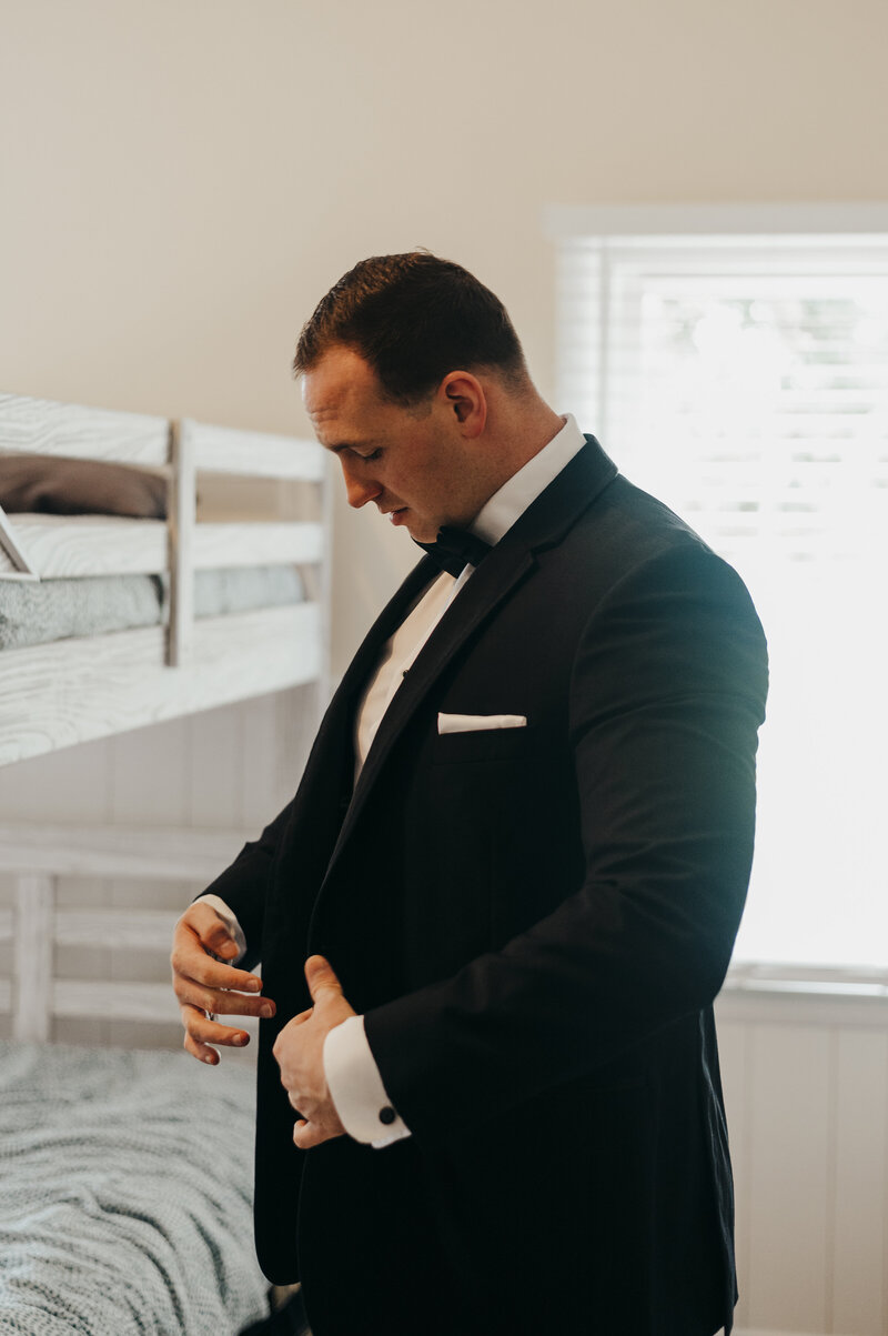 groom adjusting suit