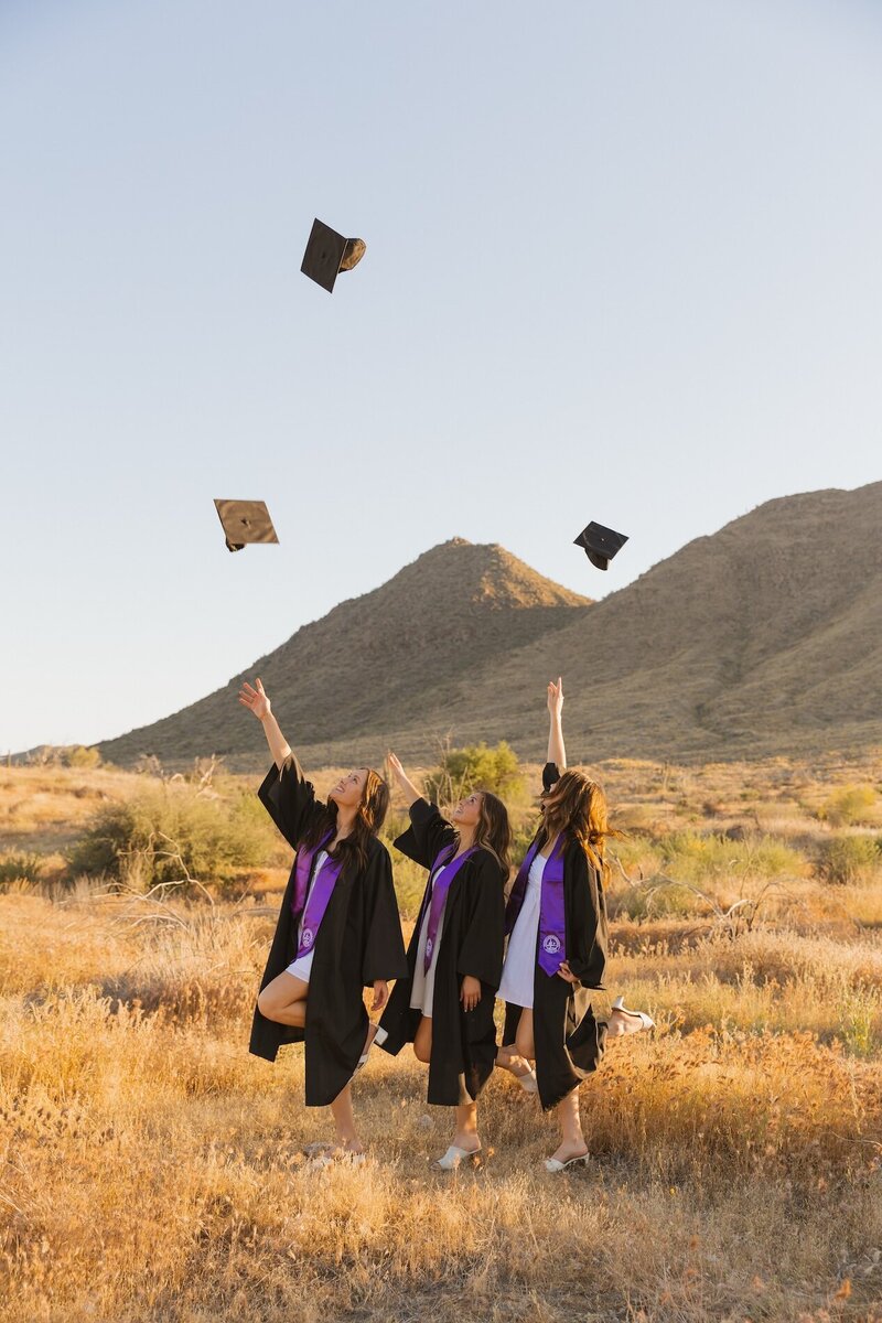 the graduates toss up their caps in arizona field