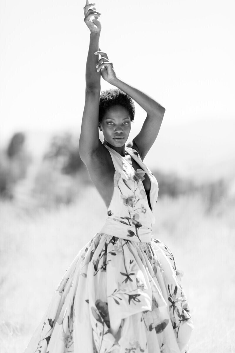 Black and white fashion editorial woman poses outdoors