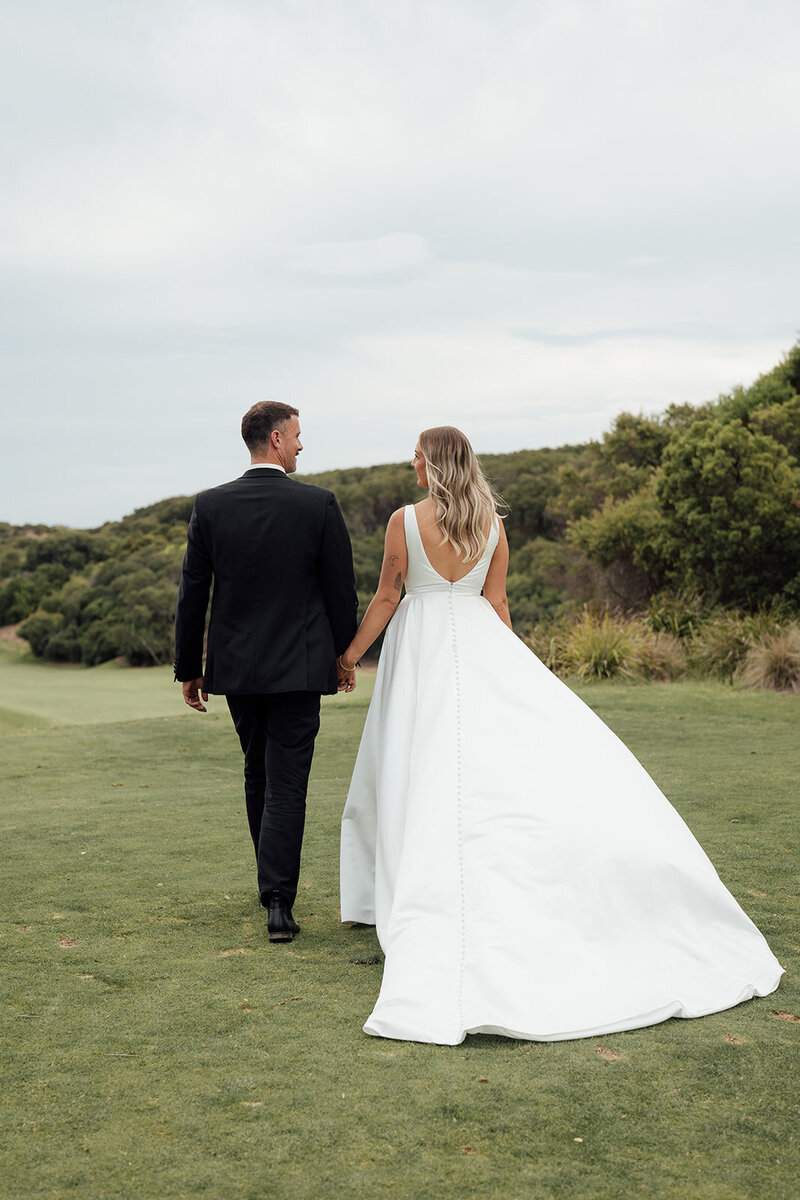 newly wed couple walking on the warrnambool golf course greens