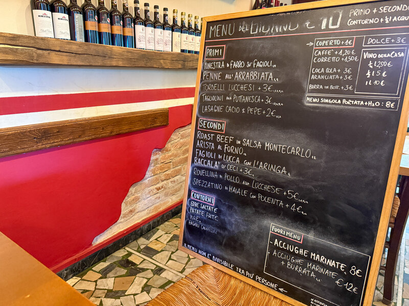 Chalkboard with daily menu at Locando Buatino in Lucca, Italy