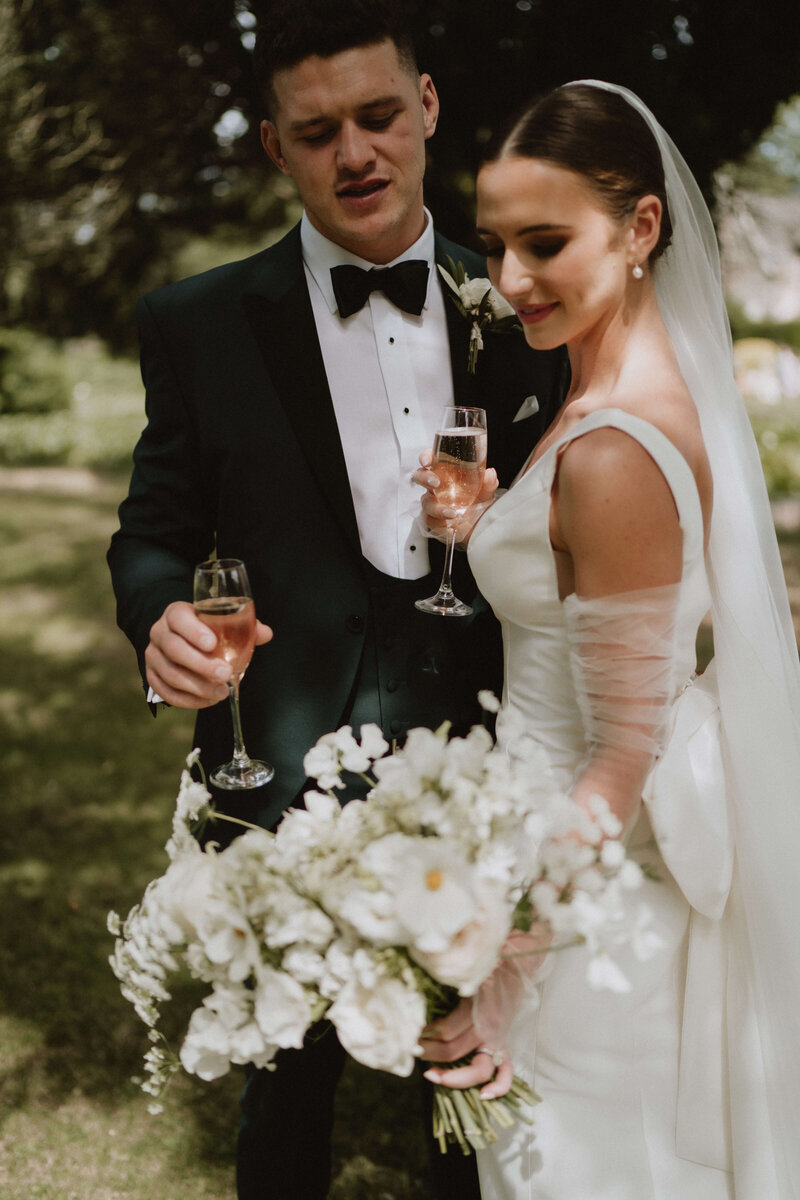Bride and groom drinking champagne at Brinsop Court