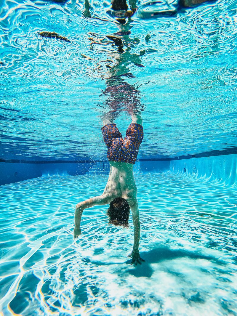 boy swimming in a pool maintained by Top-rated Hampton Roads swimming pool management