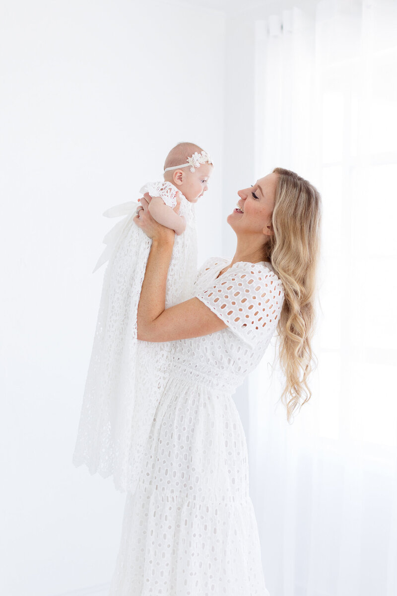 Mom holding baby in the air in Boise studio.