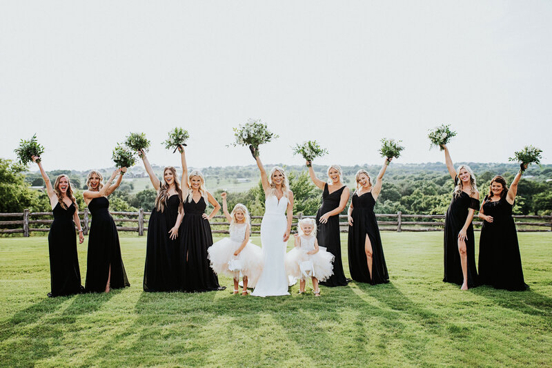 bride and bridal party holding up wedding flowers