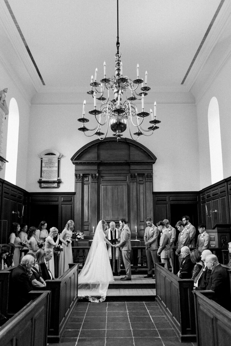 Bride and groom at the altar of Wren Chapel during a Williamsburg wedding planned by Sweet Caroline Events taken by Morgan Renee Photography