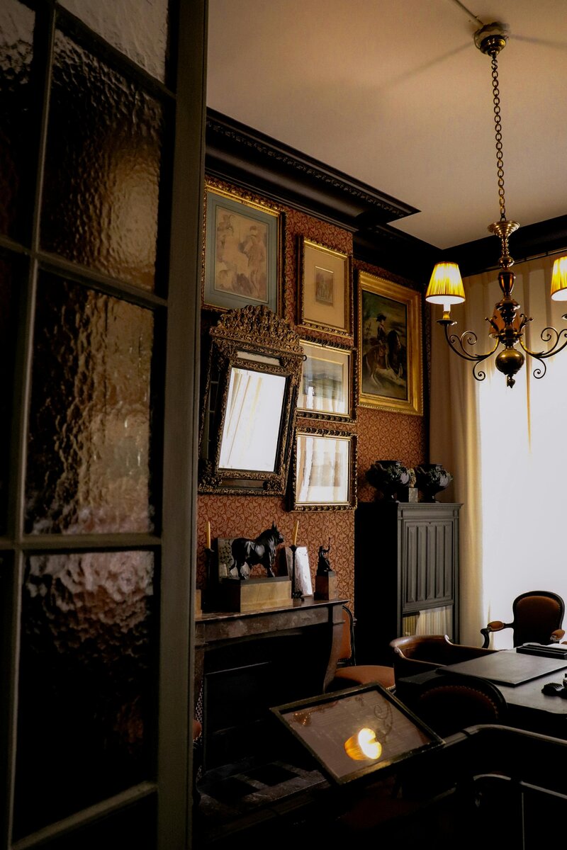 Moody office with vintage furniture and framed pictures, creating a classic, thoughtful atmosphere ideal for copy editing and professional proofreading services.